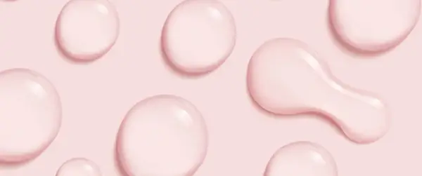 Gocce rosa su sfondo rosa, simili a quelle che si trovano in prodotti con cetearyl alcohol cos'è, un ingrediente emolliente.